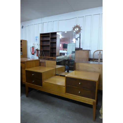 160 - A Uniflex teak and afromosia dressing table and pair of matching bedside cupboards