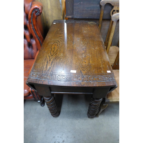 195 - A carved oak barleytwist gateleg table