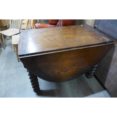 195 - A carved oak barleytwist gateleg table