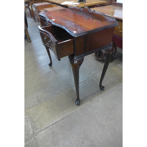 204 - A mahogany two drawer serpentine side table