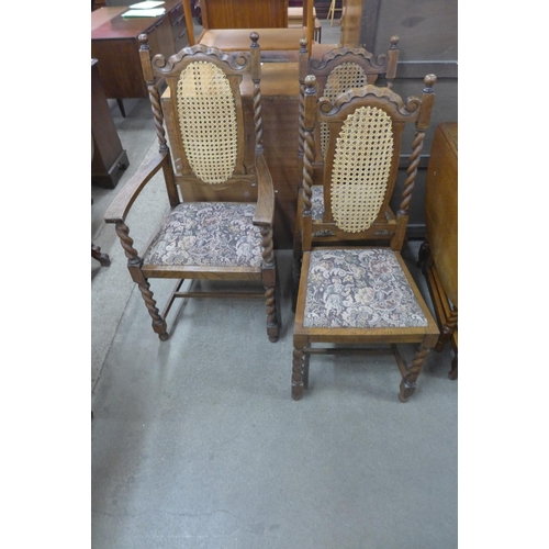 211 - An oak barleytwist draw-leaf table and three chairs