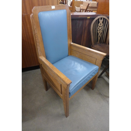 215 - An Art Deco style oak and faux blue leather ecclesiastical chair