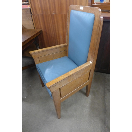 215 - An Art Deco style oak and faux blue leather ecclesiastical chair