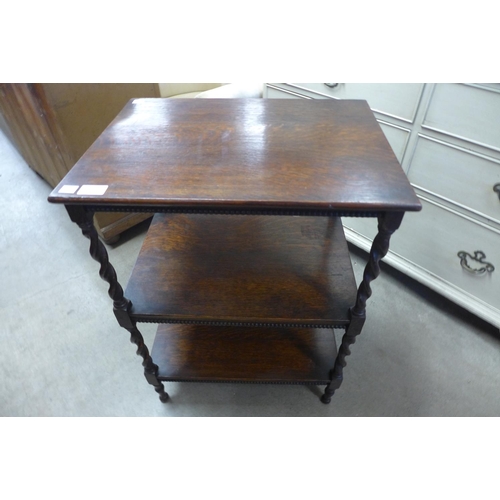 222 - An oak barleytwist three tier occasional table