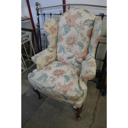 321 - A Queen Anne style mahogany and upholstered wingback armchair