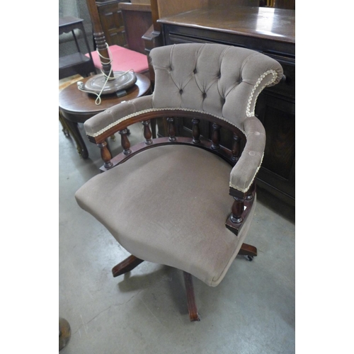 323 - A beech and upholstered revolving desk chair