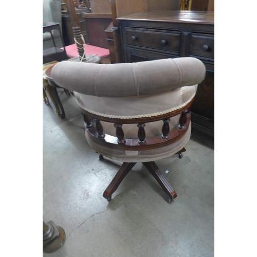 323 - A beech and upholstered revolving desk chair