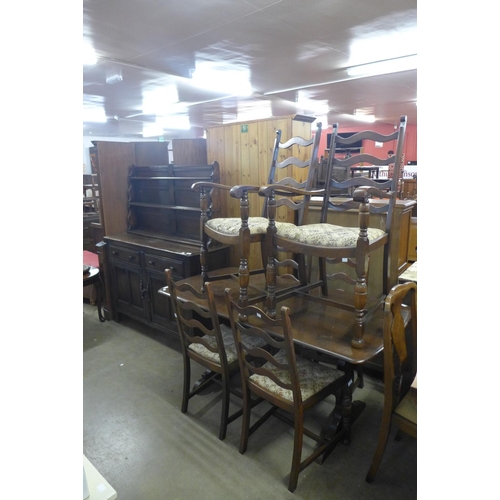 325 - An Ercol Old Colonial dark elm dresser, refectory table and six ladderback chairs