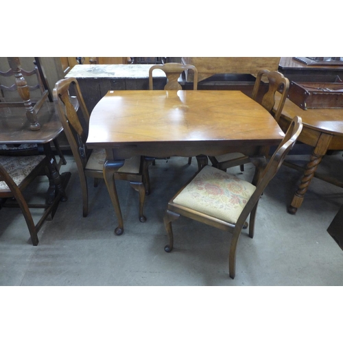 326 - A walnut draw-leaf dining table and four chairs