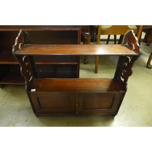 328 - An Edward VII carved mahogany wall shelf and a mahogany open bookcase