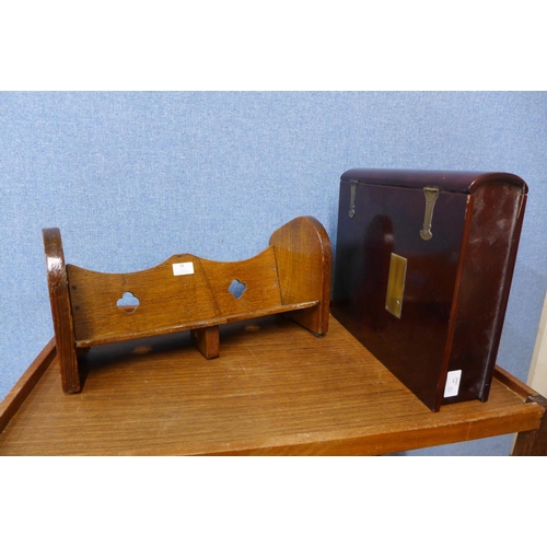 33 - An Arts and Crafts oak book trough and a hardwood and brass mounted book shaped folio box