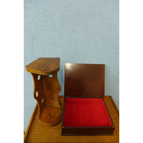 33 - An Arts and Crafts oak book trough and a hardwood and brass mounted book shaped folio box