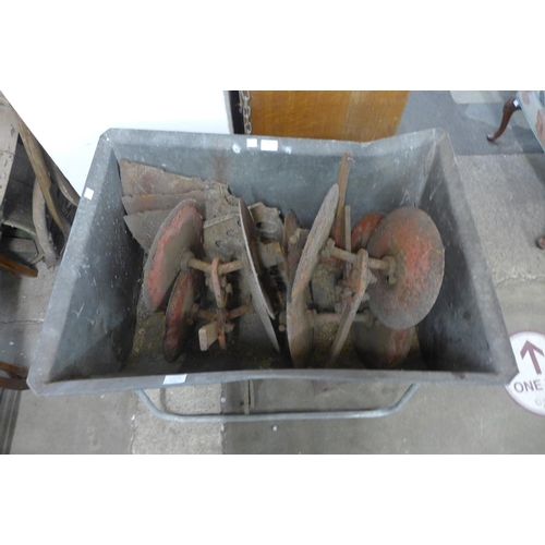 341 - A galvanised trough on stand and agricultural tool implements