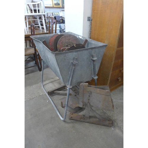 341 - A galvanised trough on stand and agricultural tool implements