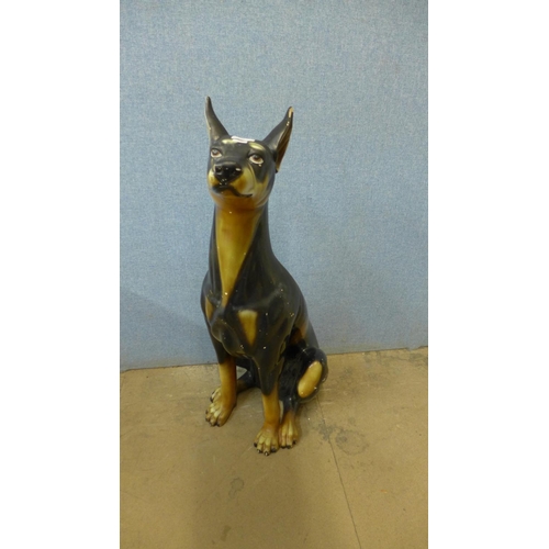 395 - A painted pottery figure of a Doberman