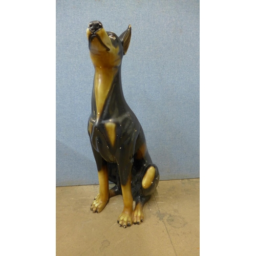 395 - A painted pottery figure of a Doberman