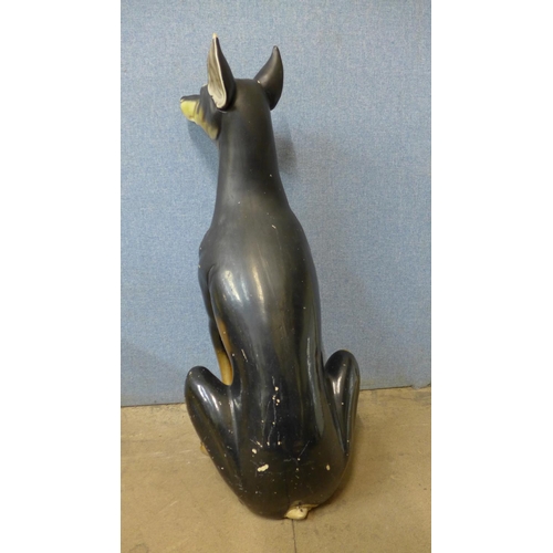 395 - A painted pottery figure of a Doberman