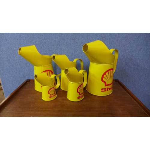 404 - A set of five graduated Shell advertising jugs