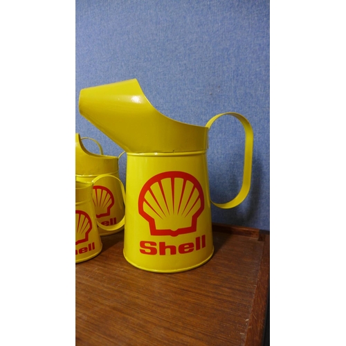 404 - A set of five graduated Shell advertising jugs