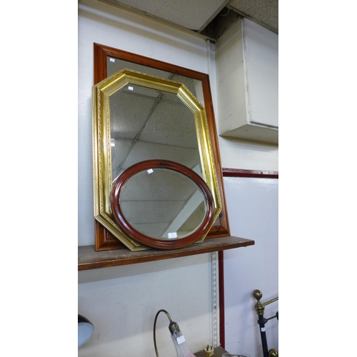 412 - A pine mirror, a gilt framed mirror and an oval mahogany mirror