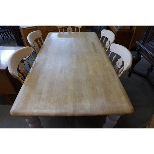 52 - A painted beech farmhouse kitchen table (74cms h, 184cms l, 99cms w) and six beech chairs