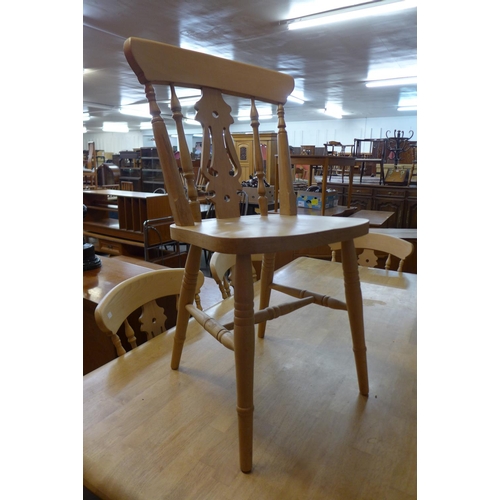 52 - A painted beech farmhouse kitchen table (74cms h, 184cms l, 99cms w) and six beech chairs