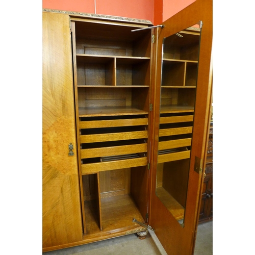 54 - A pair of Art Deco walnut, burr walnut and parcel gilt fitted wardrobes, 194cms h, 169cms w, 56cms d... 