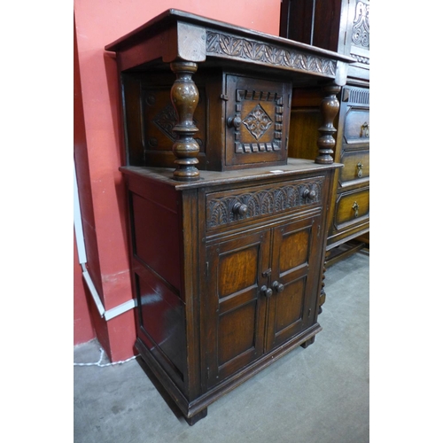 55 - A carved oak dwarf court cupboard, 111cms h x 69cms w