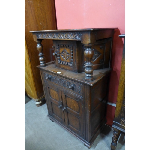 55 - A carved oak dwarf court cupboard, 111cms h x 69cms w