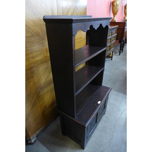 57 - An early 20th Century Jacobean Revival carved oak open bookcase, 130cms h x 68cms w