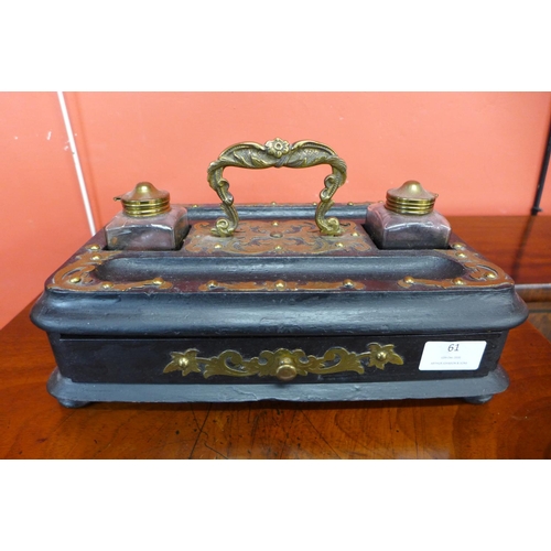 61 - A Victorian ebonised double inkwell stand with applied brass fretwork decoration, 16cms h x 31cms w