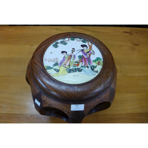 64 - A Chinese hardwood stand, inset with circular porcelain plaque painted with musicians, 34cms h