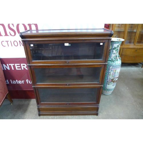 69 - An early 20th Century Globe Wernicke oak three tier sectional stacking bookcase, 115cms h 87cms w, 2... 