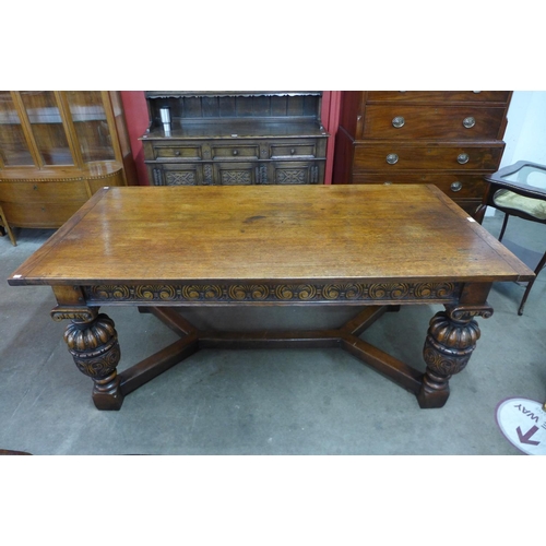 77 - An Elizabethan Revival carved oak refectory table, 76cms h, 183cms l, 91cms w