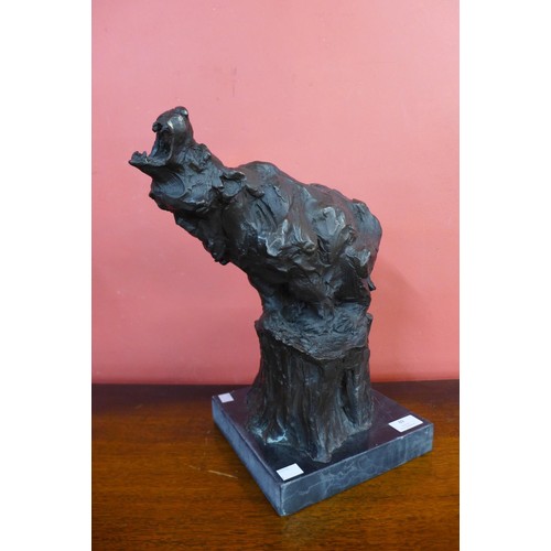 89 - A bronze figure of a grizzly bear, on black marble socle, 39cms h