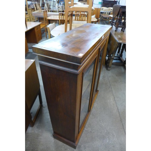 90 - A Victorian walnut two door bookcase, 106cms h, 89cms w, 29cms d