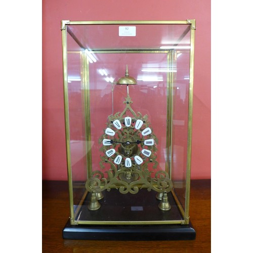 92 - A cased brass fusee skeleton clock, 53cms h