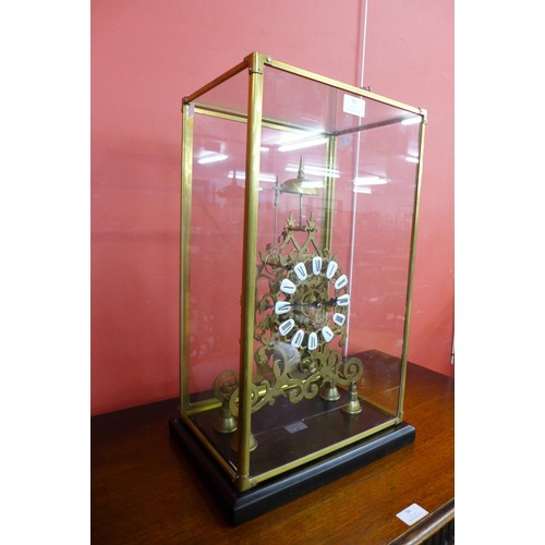 92 - A cased brass fusee skeleton clock, 53cms h