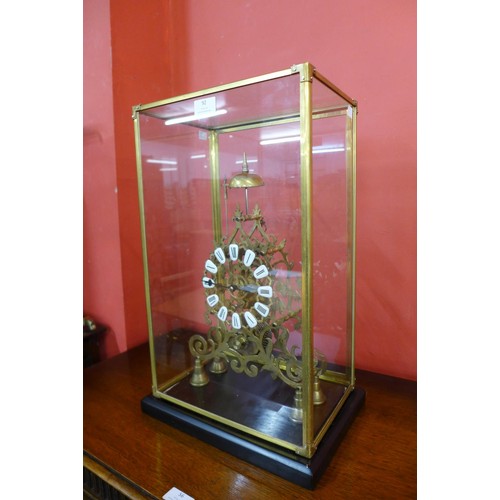 92 - A cased brass fusee skeleton clock, 53cms h