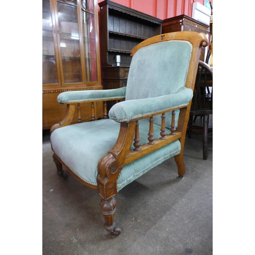 82 - A pair of Victorian Gothic Revival oak and upholstered lady's and gentleman's chairs