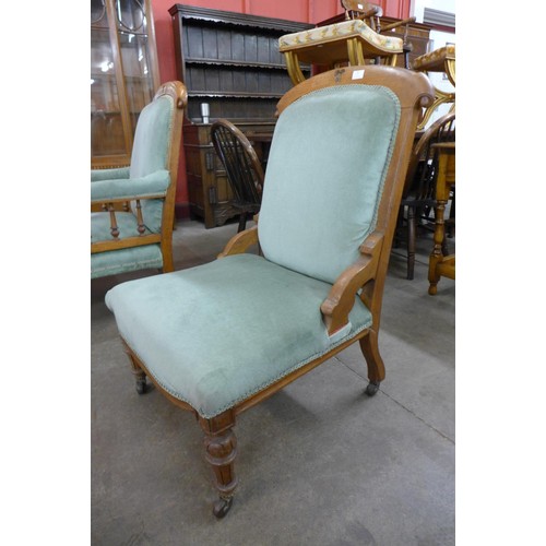 82 - A pair of Victorian Gothic Revival oak and upholstered lady's and gentleman's chairs