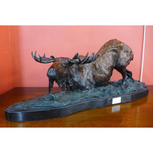 85 - A cold painted bronze figure of a moose, on black marble plinth, 26cms h x 61cms w