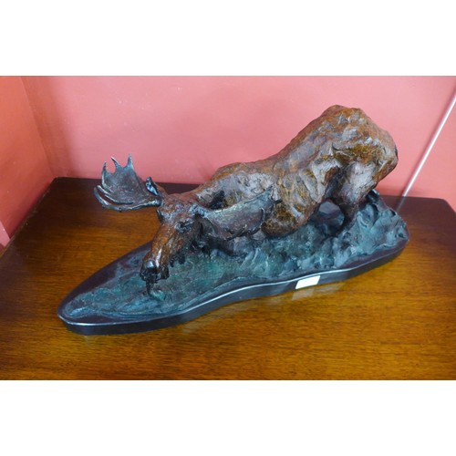 85 - A cold painted bronze figure of a moose, on black marble plinth, 26cms h x 61cms w