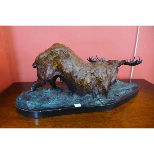 85 - A cold painted bronze figure of a moose, on black marble plinth, 26cms h x 61cms w