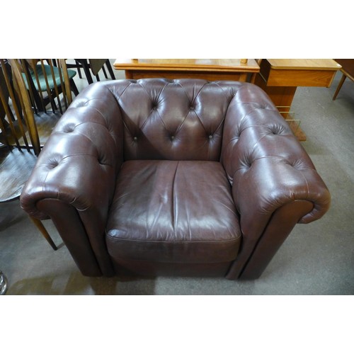 87 - A brown faux leather Chesterfield club chair, 71cms h, 103cms w, 87cms d