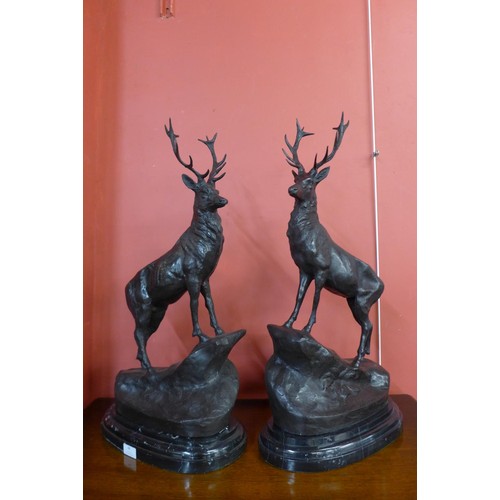 88 - A pair of French style bronze stags, on black marble plinths, 73cms h