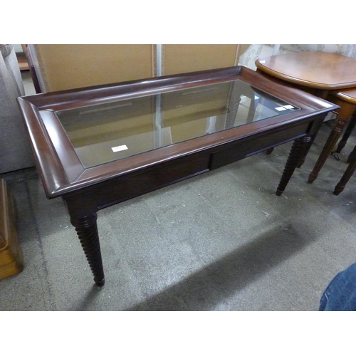 1876 - A mahogany and glass coffee table