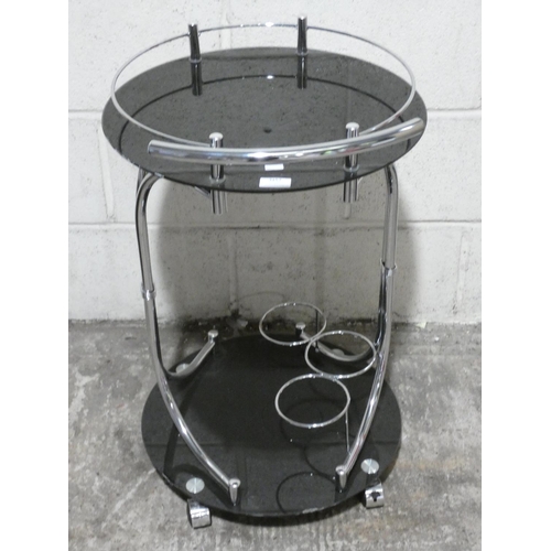 3157 - A black glass serving trolley * this lot is subject to VAT