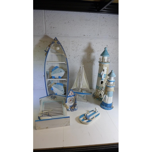 2103 - Tub of fishing/nautical related decor including:- lighthouse, boat, yacht, etc.