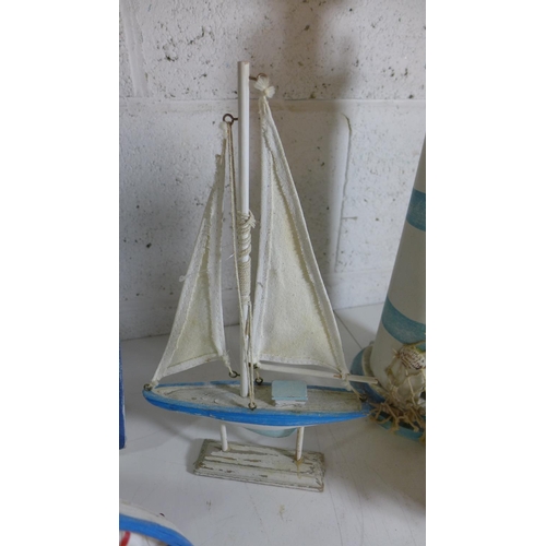 2103 - Tub of fishing/nautical related decor including:- lighthouse, boat, yacht, etc.